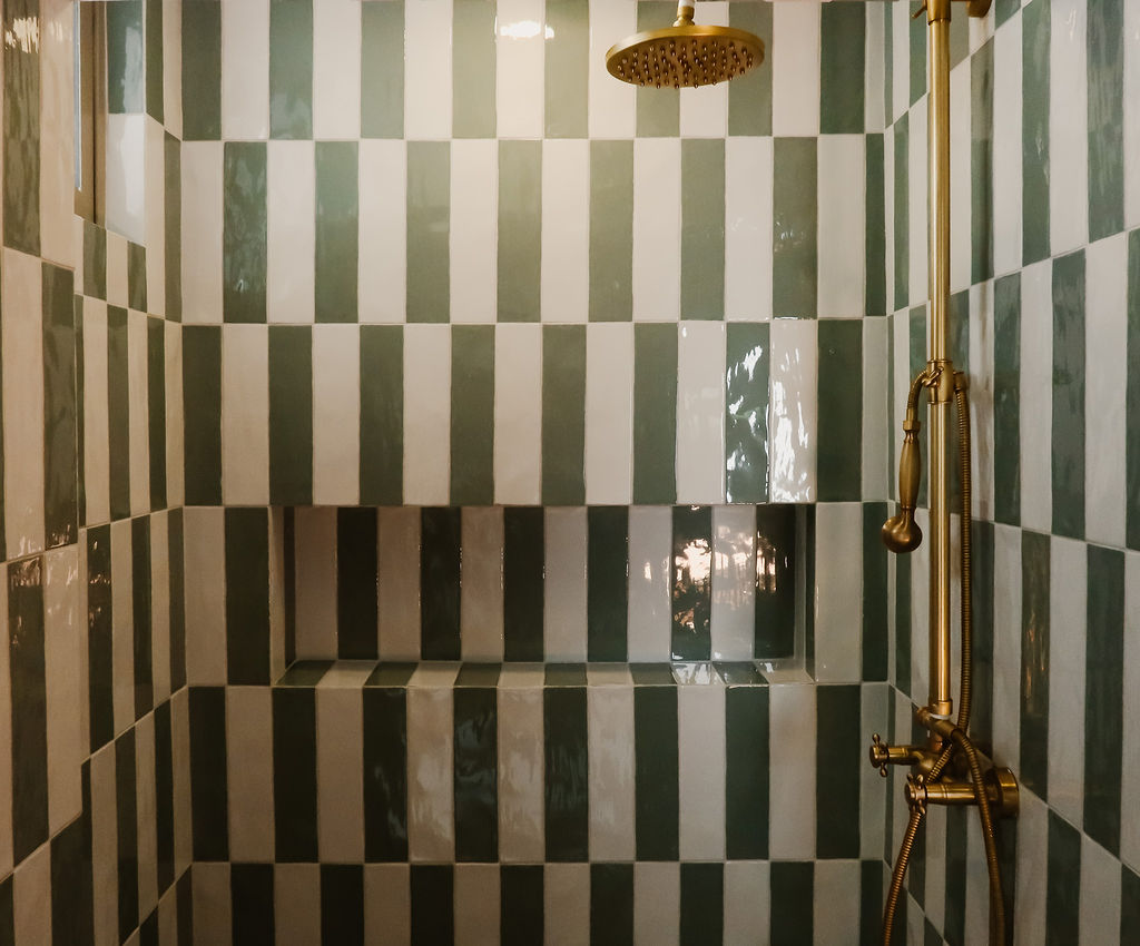 The Green Room — green checkerboard tile shower with brass fixtures