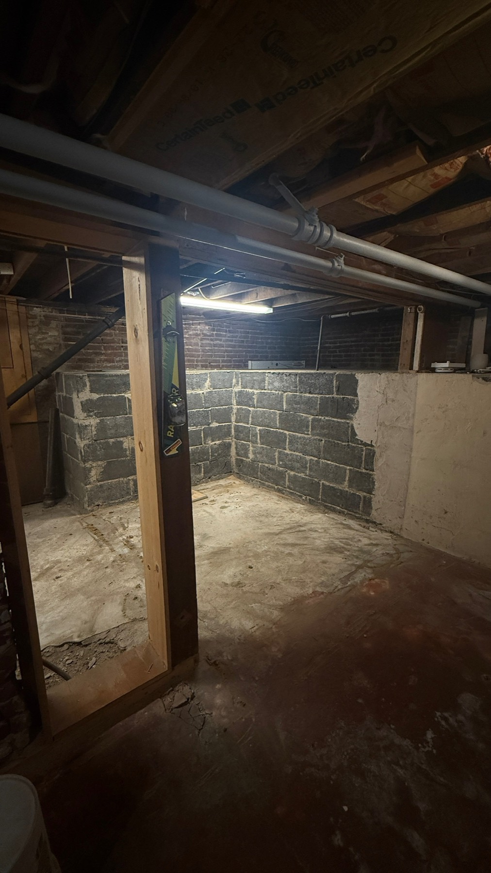 The unfinished basement corner before the powder room was built